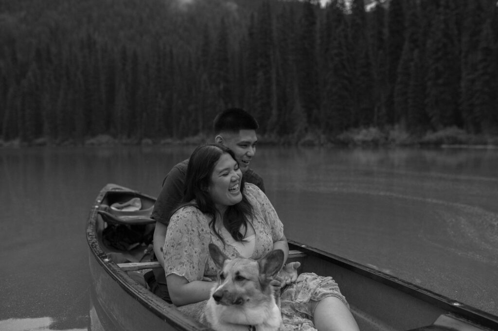 candid black and white photo of couple in canoe during an engagement session