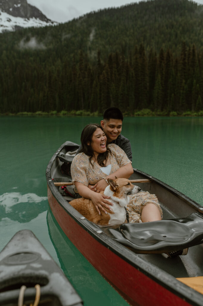 couple enjoying time together in the rain during their canoe ride on emerald lake, canada