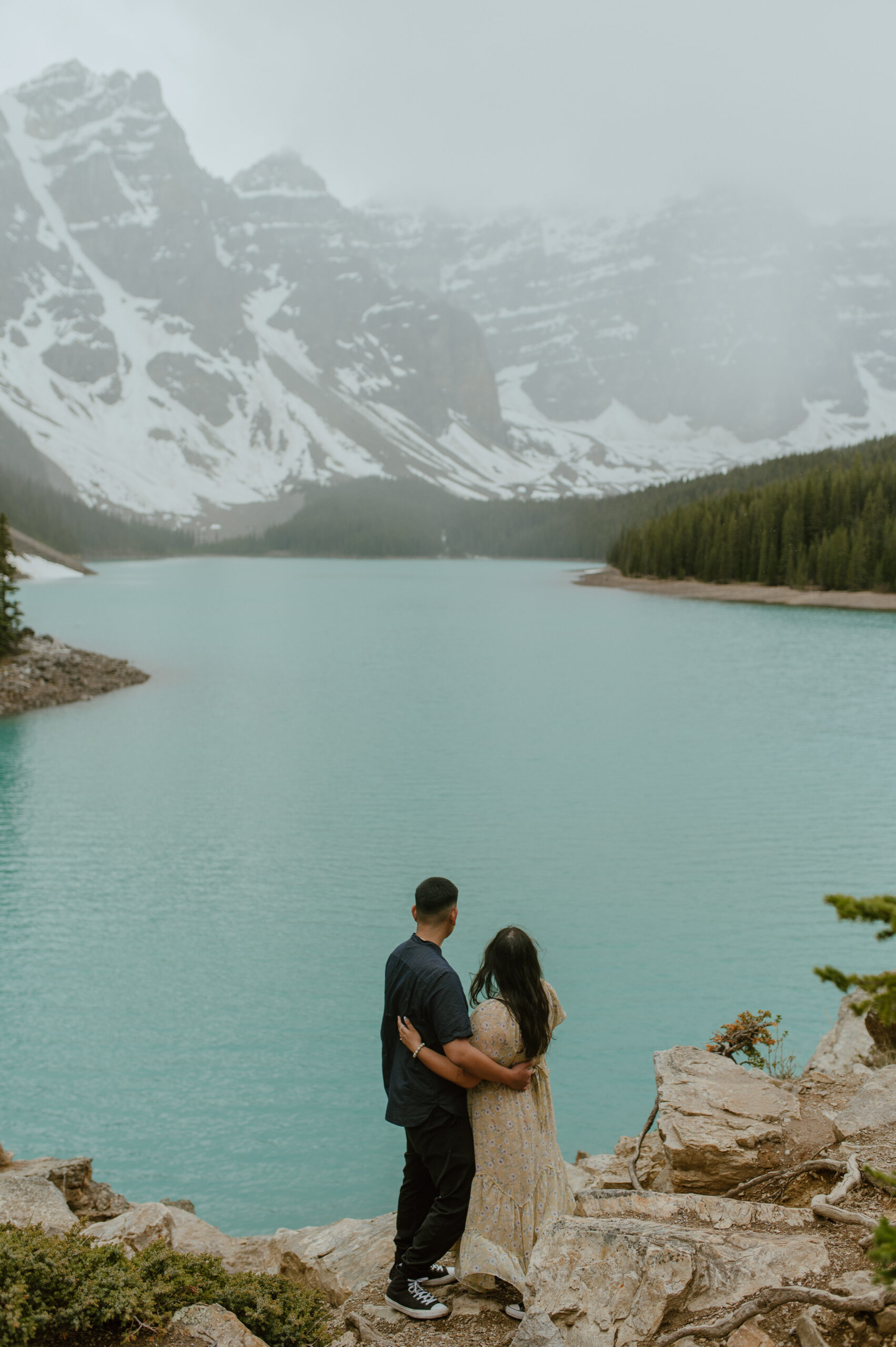 couple looking at ten peaks behind Moraine Lake in Banff National Park, Canada
