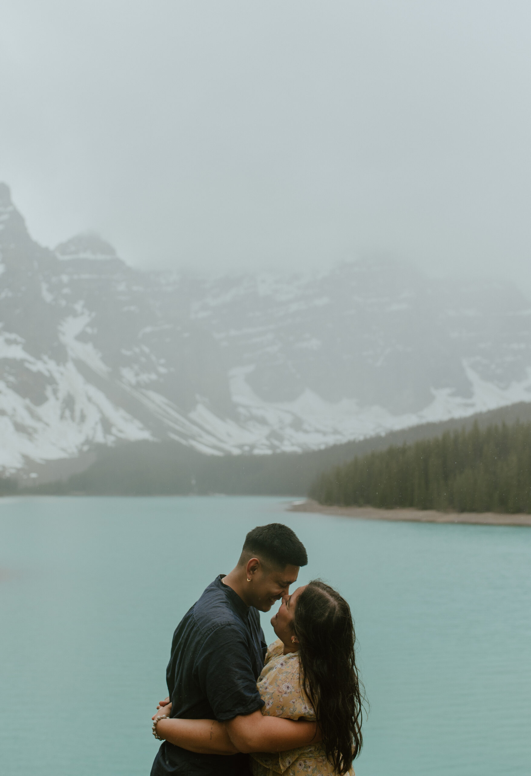 couple engagement session in the rain at Moraine Lake, Canada