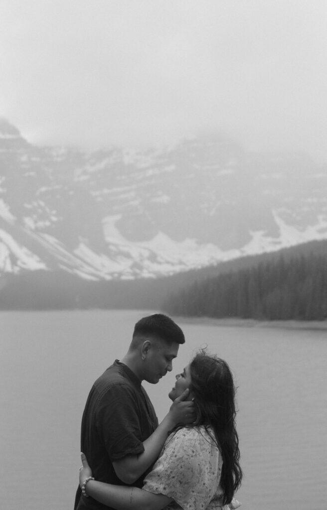 black and white photo of couple during adventure engagement session in Banff, Canada