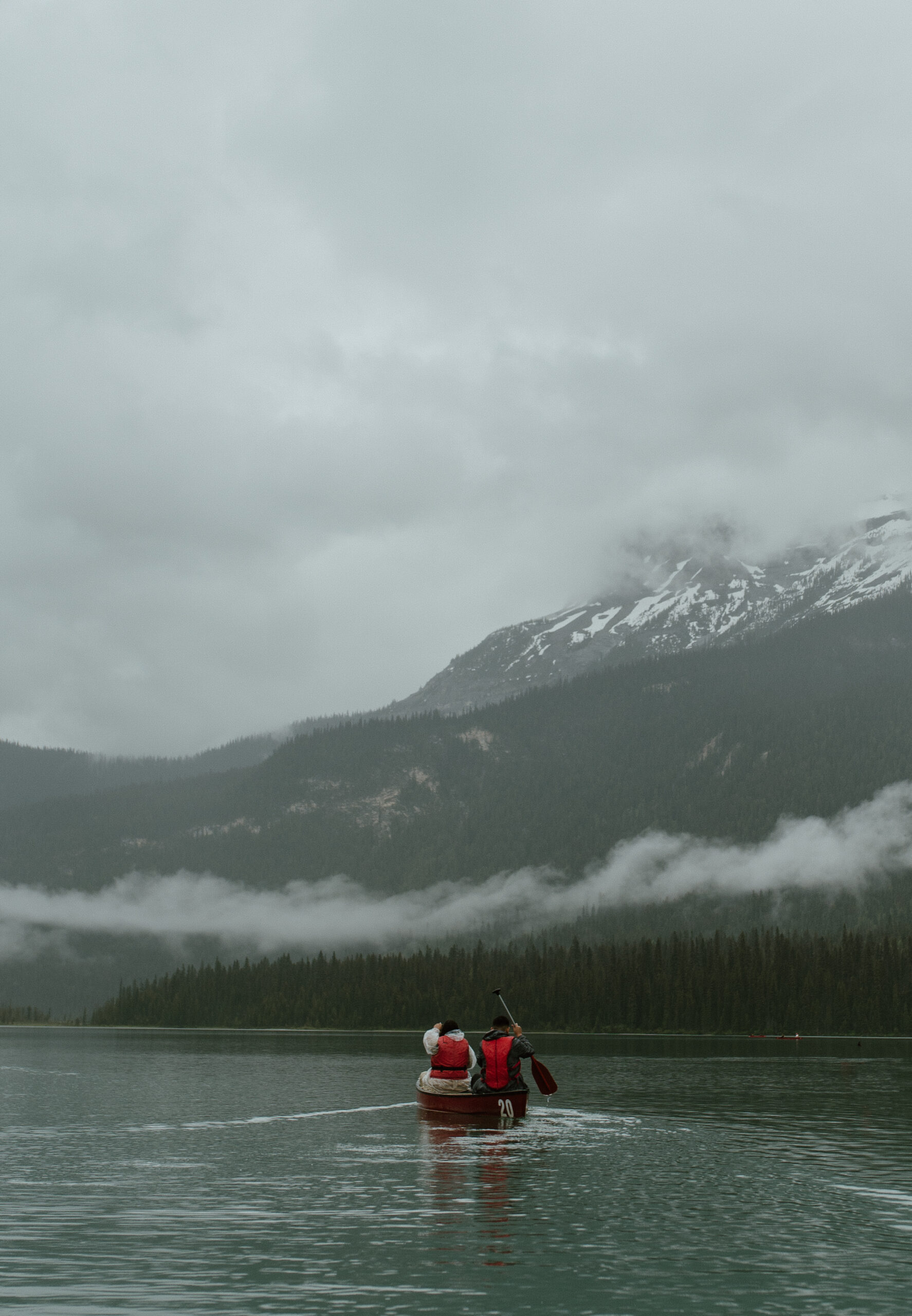 couple canoeing on gloomy day at Emerald Lake, BC, Canada