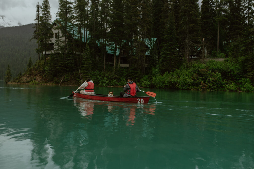 couple canoeing on blue glacier lake in Canada