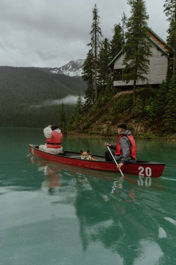 couple with dog canoeing on Emerald Lake, BC, Canada