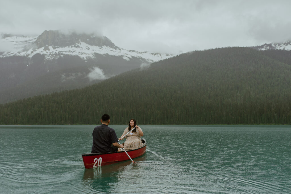 couple canoeing for engagement session on Emerald Lake in the rocky mountains