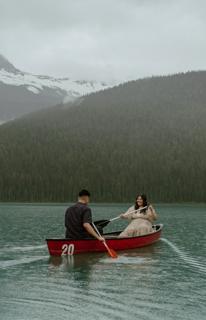 couple canoeing in the rain for an engagement session in British Columbia, Canada