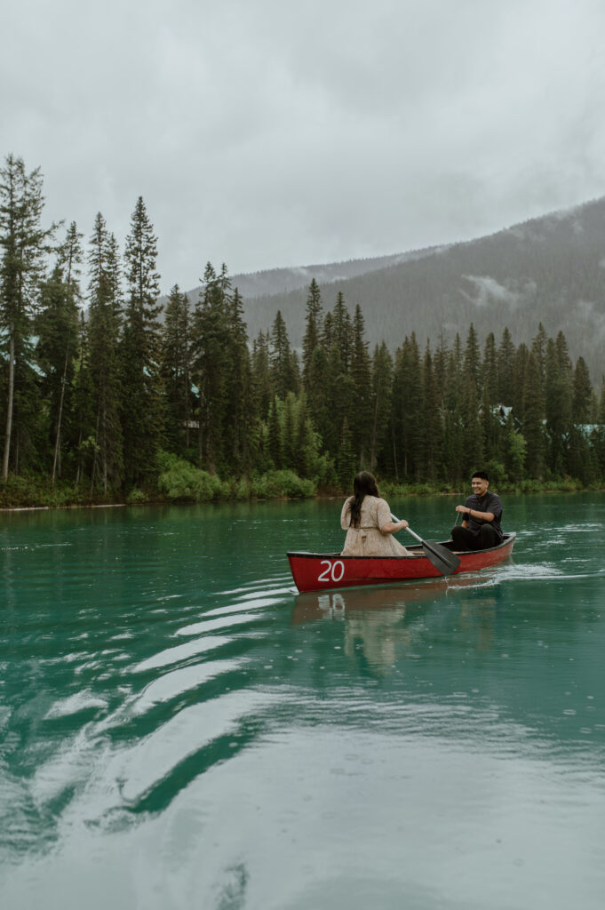 couple laughing in canoe during an engagement session in BC, Canada