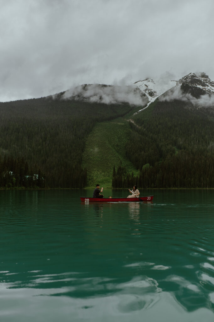 couple canoeing on Emerald Lake for an engagement shoot in Banff, Canada