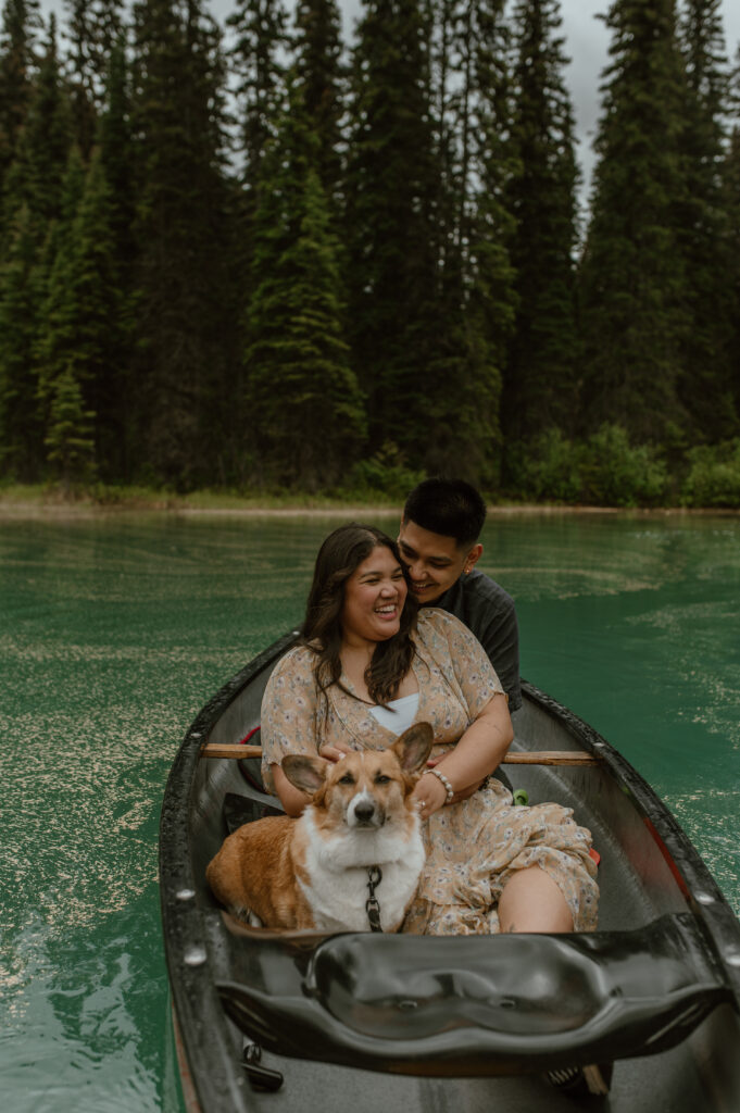 couple laughing in canoe during an engagement session in Banff, Canada
