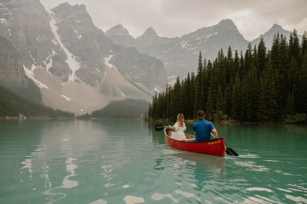 couple canoeing on Moraine Lake in Banff, Alberta