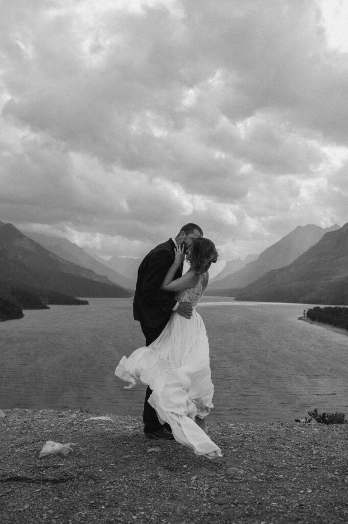 couple posing in front of Waterton Lakes National Park in Alberta