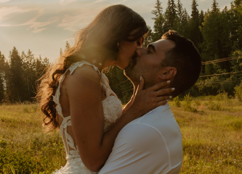 intimate kissing couple during small summer mountain wedding in British Columbia