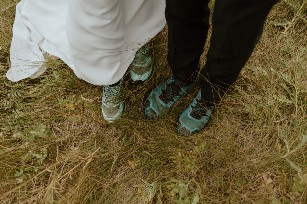 detail shot of trail runners worn on wedding day in Alberta, Canada