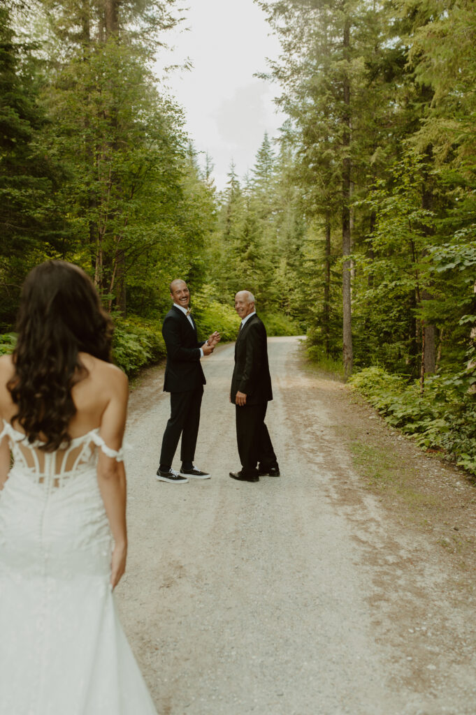 first look with father and brother during intimate summer mountain wedding in Golden, BC