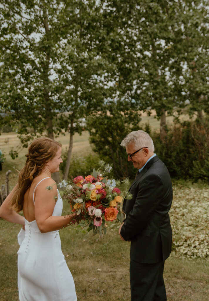 first look with father and daughter on wedding day in Longview, Alberta