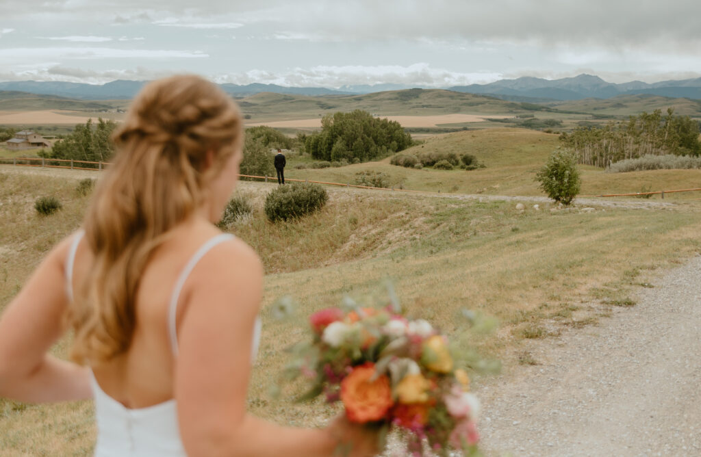 bride walking to future husband for their first look in Southern Alberta