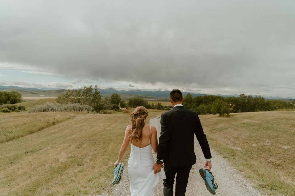 outdoorsy bride and groom taking portraits in the foothills of Southern Alberta