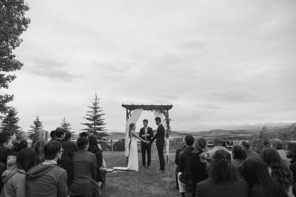 black and white photo of wedding ceremony in the foothills of Alberta