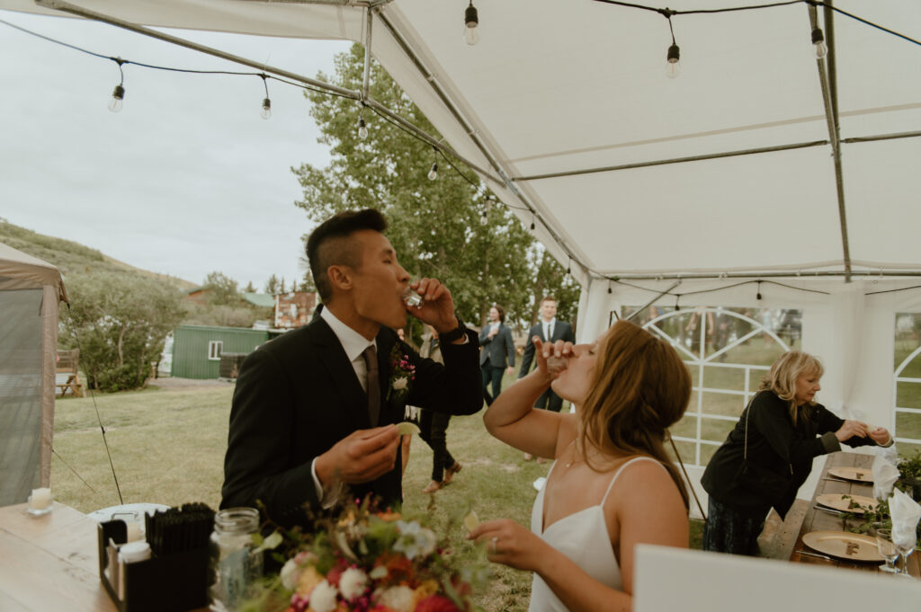 post ceremony tequila shot with bride and groom in Southern Alberta