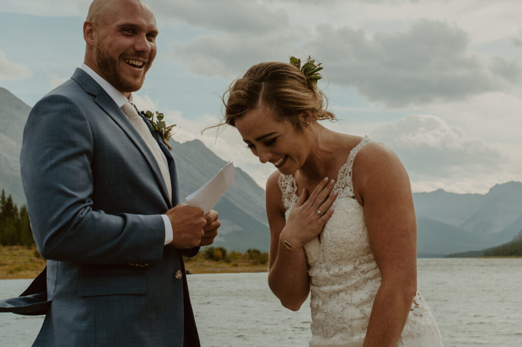 wedding couple sharing laughs during vows in Banff, Alberta