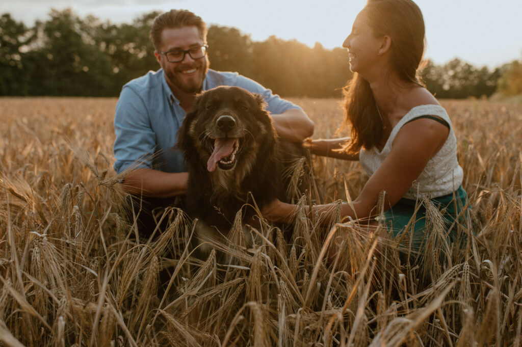 couple and dog sharing candid laughs during sunset in Ontario, Canada