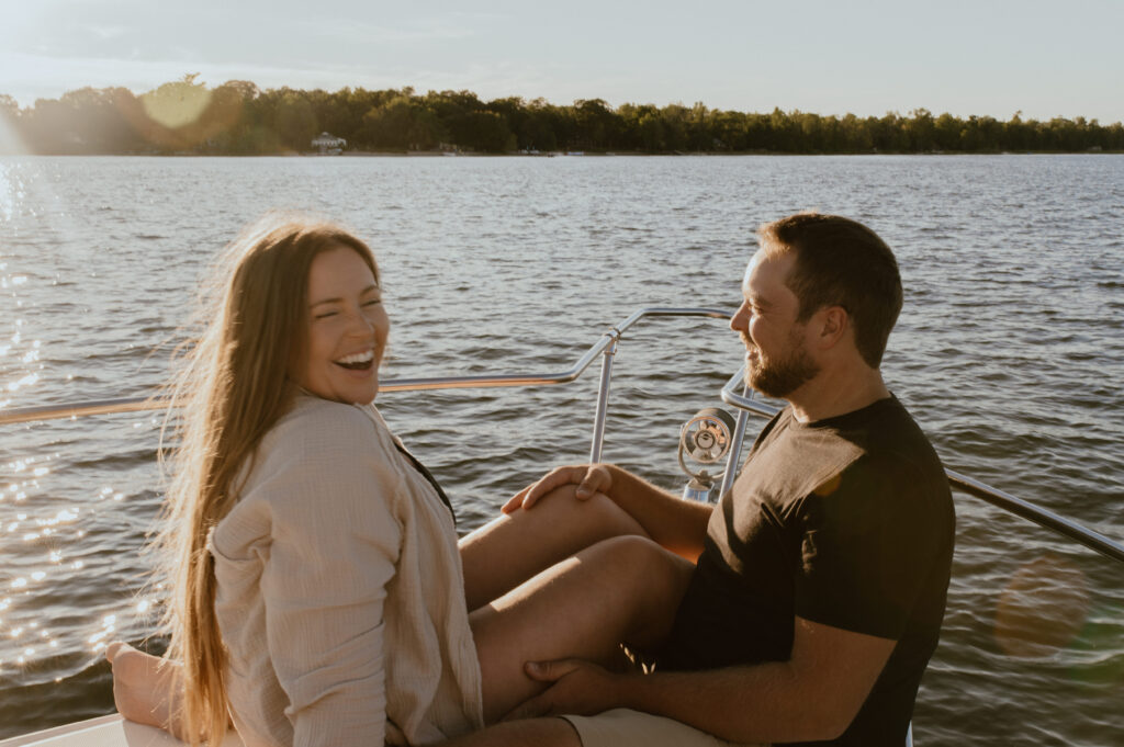 couple on sunset cruise in Muskoka, Ontario for engagement session