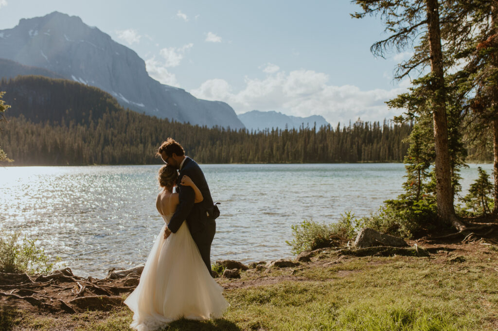 couple enjoying first dance beside a private mountain lake for an elopement in Banff, Canada