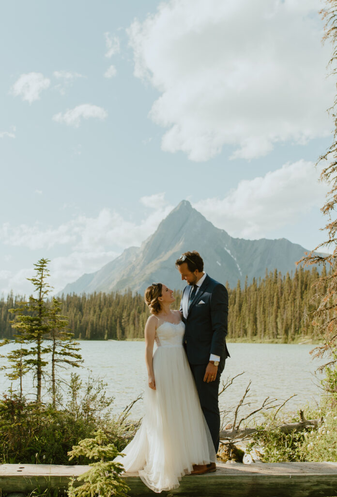wedding portraits in front of mountain lake after hiking during an elopement in Banff, Canada
